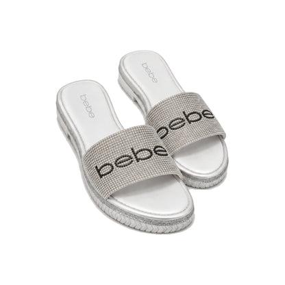 Bebe Rhinestone Logo Slide Sandals In White/Silver